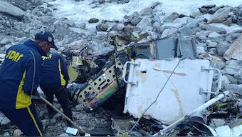 SDRF officials inspecting the crashed helicopter's debris. Source: X