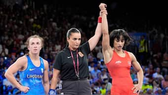 India's Vinesh Vinesh, right, celebrates after defeating Ukraine's Oksana Livach during their women's freestyle 50kg quarterfinal wrestling match, at Champ-de-Mars Arena, during the 2024 Summer Olympics, Tuesday, Aug. 6, 2024, in Paris, France. (AP Photo/Eugene Hoshiko)