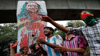Protesters shout slogans as they vandalise a mural of now former Bangladeshi Prime Minister Sheikh Hasina with paint and mud at Teacher Student Centre (TSC) area of University of Dhaka in Dhaka, Bangladesh. Reuters