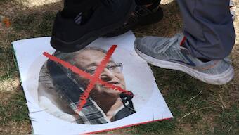 People step on an image as they react to the resignation of Bangladeshi Prime Minister Sheikh Hasina, in East London, Britain. An interim government will now take over the administration of the country. Reuters