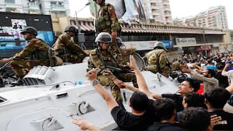 People shake hands with army personnel as they celebrate the resignation of Bangladeshi Prime Minister Sheikh Hasina in Dhaka, Bangladesh. Reuters