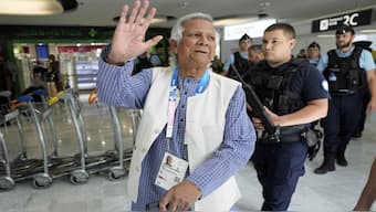 Nobel laureate Muhammad Yunus waves to the media at Charles de Gaulle's airport in Roissy, north of Paris, before making his way to Bangladesh where he was sworn in as interim chief. AP