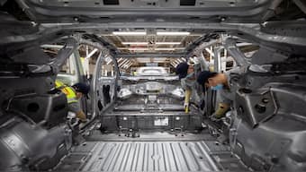Employees work on an electric vehicle (EV) production line at a Volkswagen Anhui factory in Hefei, Anhui province, China. Reuters