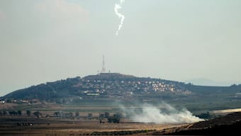 Smoke rises and a flare is deployed in the southern Lebanese Marjayoun plain after being hit by Israeli shelling on September 7, 2024, amid the ongoing cross-border clashes between Israeli troops and Hezbollah fighters. AFP