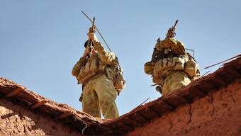 Australian soldiers from the Special Operations Task Group using their rifle scopes to investigate the surrounding mountains during an operation in southern Afghanistan. File Image: AFP