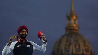 Harvinder Singh poses with the gold medal that he won at the Paris Paralympics. AP 