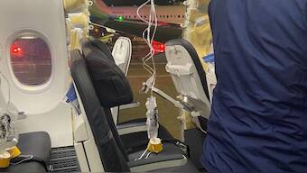 Passenger oxygen masks hang from the roof next to a missing window and a portion of a side wall of an Alaska Airlines Flight 128. Source: REUTERS.