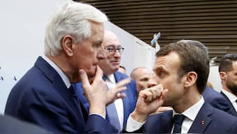 French President Emmanuel Macron speaks with then EU Chief Brexit Negotiator Michel Barnier as he visits the International Agriculture Fair (Salon de l'Agriculture) in Paris, France, February 23, 2019. File Image/Reuters