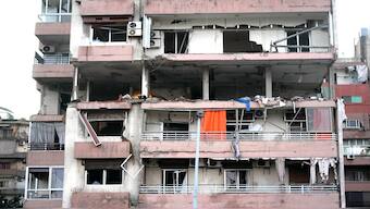 Damages are seen on a building that was hit by Israeli strike, early on Monday. AP