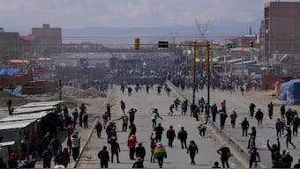 Supporters of former President Evo Morales, below, face off with supporters current President Luis Arce in El Alto, Bolivia. AP