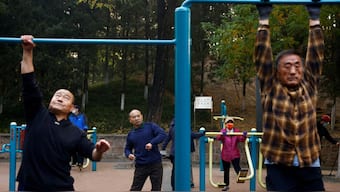 Elderly people exercise in the morning at a park in Beijing, China, November 10, 2022. File Image/Reuters