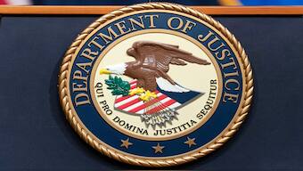 The Department of Justice seals is seen during a news conference at the DOJ office in Washington. File image/ AP