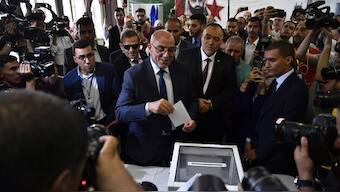 Presidential candidate of the Movement of Society for Peace (MSP), Abdelali Hassani Cherif, prepares to cast his ballot inside a polling station during the presidential election, Saturday, Sept. 7, 2024, in Algiers, Algeria.- AP