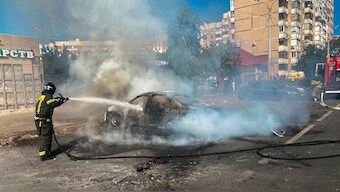 This photo released by Belgorod regional governor Vyacheslav Gladkov's Telegram channel on Sunday, Sept. 1, 2024, firefighters extinguish a burning car in the courtyard of an apartment building after a missile attack by the Armed Forces of Ukraine on the city of Belgorod and the Belgorod region of Russia.  Photo- AP