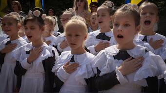 Schoolgirls sing the national anthem on the first day at school in a cadet lyceum in Kyiv, Ukraine, Monday, Sept. 2, 2024. - AP