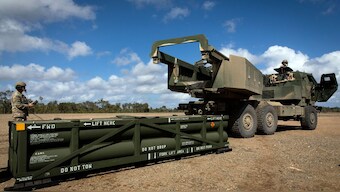 In this image provided by the US Army, Sgt Ian Ketterling, gunner for Alpha Battery, 1st Battalion, 3rd Field Artillery Regiment, 17th Field Artillery Brigade, prepares the crane for loading the Army Tactical Missile System (ATACMS) on to the High Mobility Artillery Rocket System (HIMARS) in Queensland, Australia. AP