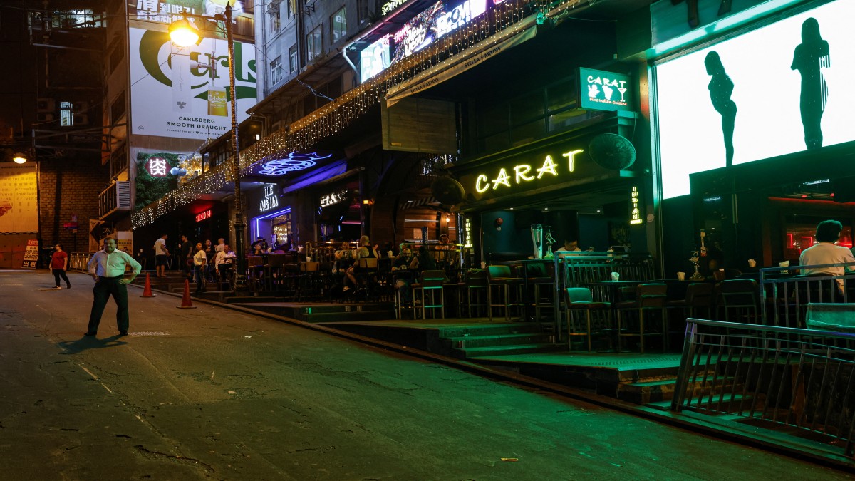 Bar staff members stand in the middle of the road to promote their bars and restaurants in Lan Kwai Fong, a popular nightlife destination, in the financial central district of Hong Kong, China. Reuters Bar staff members stand in the middle of the road to promote their bars and restaurants in Lan Kwai Fong, a popular nightlife destination, in the financial central district of Hong Kong, China. Reuters