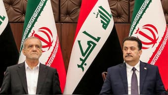 Iraq's Prime Minister Mohammed Shia al-Sudani (R) and Iran's President Masoud Pezeshkian attend a ceremony signing memoranda of understanding between Iraq and Iran at the government palace in Baghdad on September 11, 2024. AFP