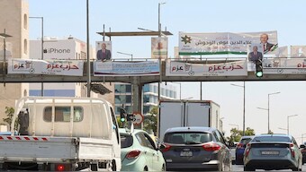 Cars pass near banners and pictures of candidates running in the country's parliamentary election in Amman, Jordan on September 7, 2024. Reuters File