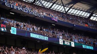 Manchester City fans celebrate at the Etihad Stadium. AP