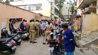 Police and locals near the crime scene after a woman was allegedly murdered in Malleswaram, Bengaluru. PTI 