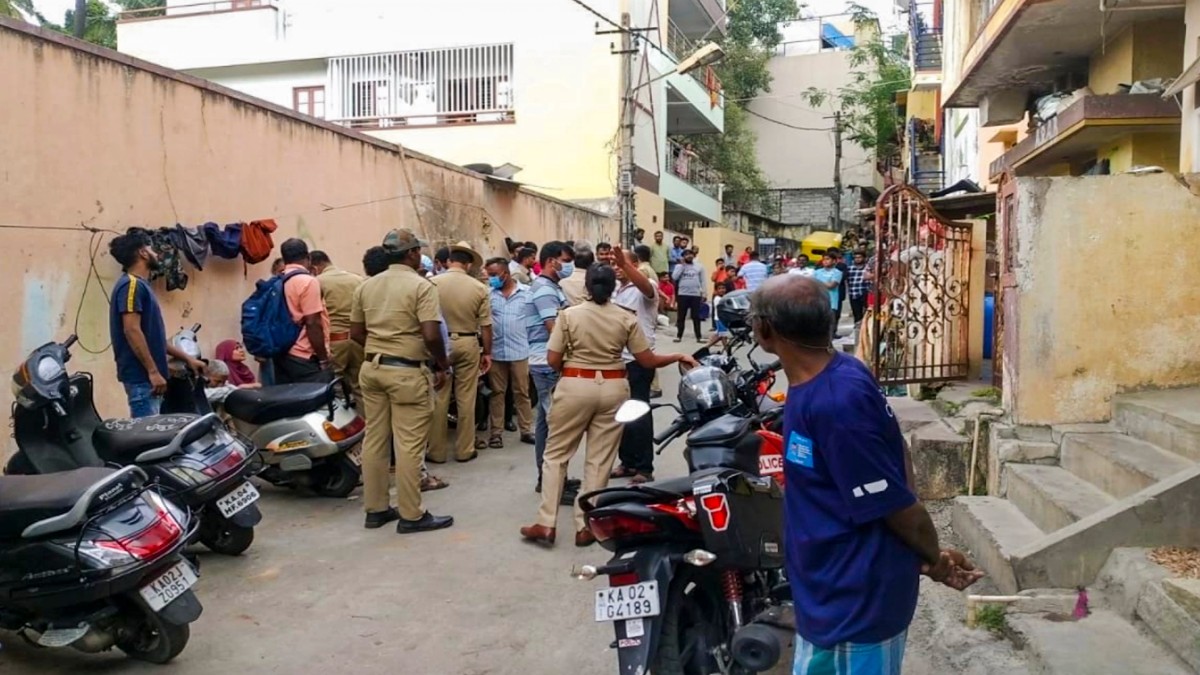 Police and locals near the crime scene after a woman was allegedly murdered in Malleswaram, Bengaluru. PTI  Police and locals near the crime scene after a woman was allegedly murdered in Malleswaram, Bengaluru. PTI