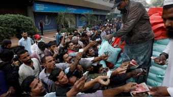Men reach out to buy subsidised flour sacks from a truck in Karachi, Pakistan January 10, 2023. Reuters