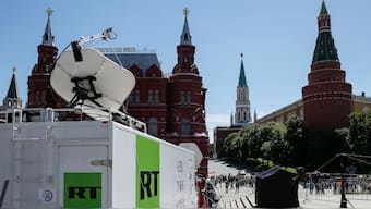 Vehicles of Russian state-controlled broadcaster Russia Today (RT) are seen near the Red Square in central Moscow, Russia, June 15, 2018. File Image/Reuters