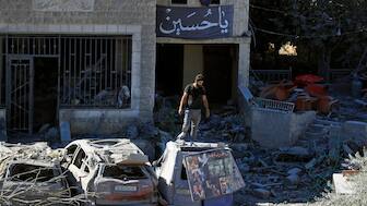 A man stands on top of a damaged car at the site of an Israeli airstrike in Saksakieh, south Lebanon, Thursday, Sept. 26, 2024. - AP