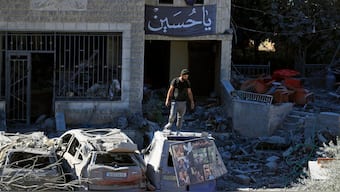 A man stands on top of a damaged car at the site of an Israeli airstrike in Saksakieh, south Lebanon, Thursday, Sept. 26, 2024. - AP