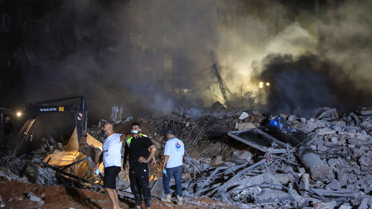 Rescuers stand on the rubble of a builiding destroyed in an Israeli air strike in the Haret Hreik neighbourhood of Beirut's southern suburbs on September 27, 2024. Photo- AFP Rescuers stand on the rubble of a builiding destroyed in an Israeli air strike in the Haret Hreik neighbourhood of Beirut's southern suburbs on September 27, 2024. Photo- AFP