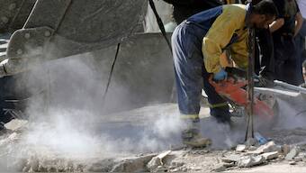 An emergency worker cuts concrete blocks as he searches for survivors at the scene of an Israeli airstrike in the town of Maisara, north of Beirut, Wednesday, Sept. 25, 2024.- AP