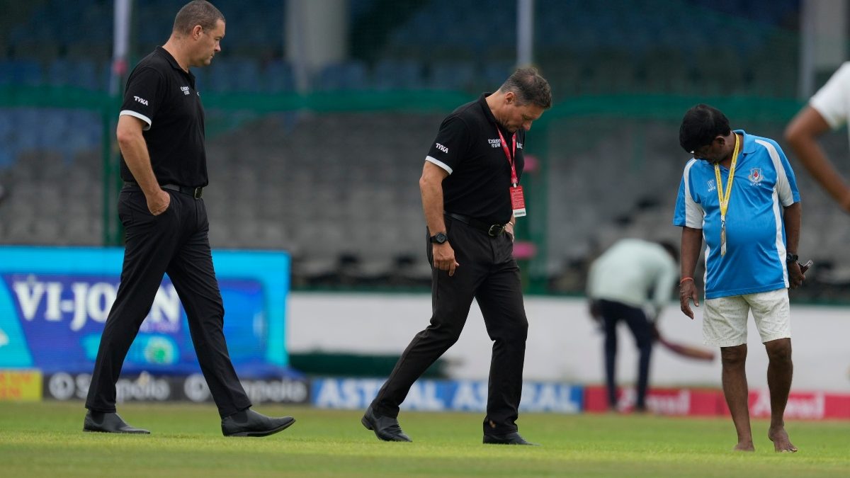 Pitch curator Shiv Kumar, right, in blue shirt, and match officials inspect the playing area on Day three of the second Test between India and Bangladesh in Kanpur. AP Pitch curator Shiv Kumar, right, in blue shirt, and match officials inspect the playing area on Day three of the second Test between India and Bangladesh in Kanpur. AP
