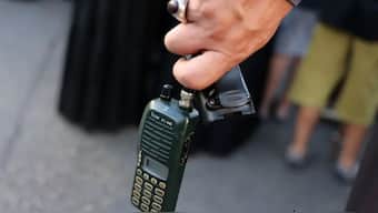 A man holding a walkie-talkie after removing the battery at a funeral in Lebanon on Wednesday. AFP