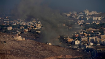 Smoke rises from an Israeli airstrike on Kfar Rouman village, as seen from Marjayoun town, south Lebanon, Monday, Sept. 23, 2024. (AP Photo/Hussein Malla)