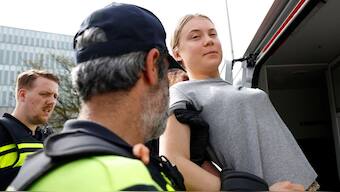 Law enforcement officials taking Greta Thunberg in custody. File Photo
