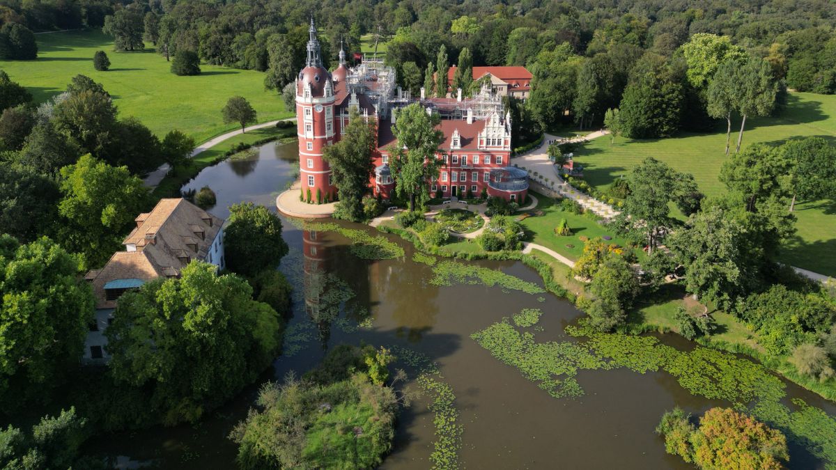 This aerial view shows the Bad Muskau palace in the landscape park in Bad Muskau, near Goerlitz in eastern Germany on August 22, 2024. In the gardens of Muskauer Park, which straddles the German-Polish border either side of the Neisse river, caretakers have mounted a fight back against the depredations caused by climate change. AFP This aerial view shows the Bad Muskau palace in the landscape park in Bad Muskau, near Goerlitz in eastern Germany on August 22, 2024. In the gardens of Muskauer Park, which straddles the German-Polish border either side of the Neisse river, caretakers have mounted a fight back against the depredations caused by climate change. AFP