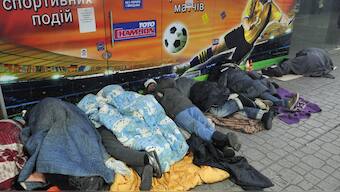 Homeless people sleep at a metro entrance in Kyiv. AFP file