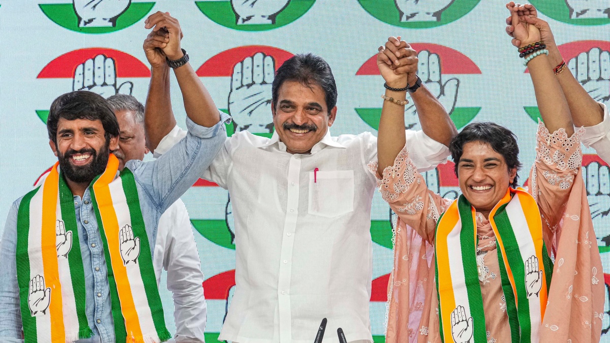 AICC General Secretary KC Venugopal (C) with wrestlers Vinesh Phogat (R) and Bajrang Punia (L) as they joined the Congress party. PTI AICC General Secretary KC Venugopal (C) with wrestlers Vinesh Phogat (R) and Bajrang Punia (L) as they joined the Congress party. PTI