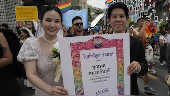 Participants hold posters celebrating equality in marriage during the Pride Parade in Bangkok, Thailand. Source: AP / FILE.