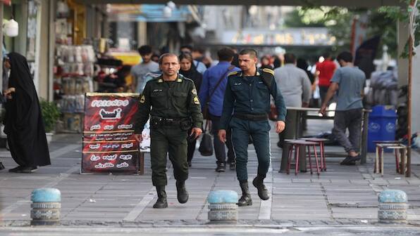 Iran: Two men hanged in a rare public execution for killing a police officer during armed robbery