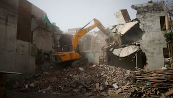 A bulldozer demolishes the house of a Muslim man that Uttar Pradesh state authorities accuse of being involved in riots that erupted following comments about the Prophet Muhammad by BJP's Nupur Sharma. The Supreme Court on September 2 sugested drawing up guidelines on demolitions to address this issue of bulldozer justice. File image/Reuters