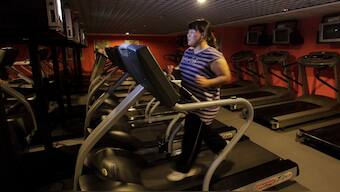 A woman runs on a treadmill in an exercise room in Beijing. The Chinese are adopting cheaper, unhealthy diets amid prolonged slow growth. File photo/Reuters