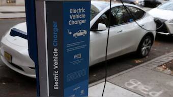 A electric vehicle charger is seen as a vehicle charges in Manhattan, New York, US. Source: REUTERS.