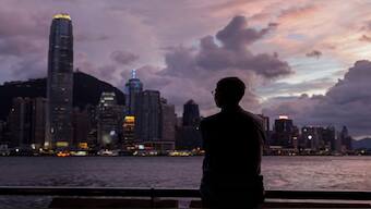  A man stands in front of Victoria Harbour, with the Central financial district in the background, as typhoon Yagi approaches in Hong Kong, China September 5, 2024. Reuters