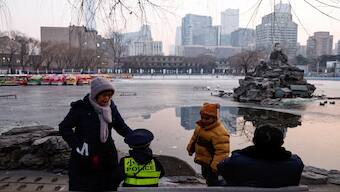 Elderly people spend time with children at a park in Beijing, China. Reuters