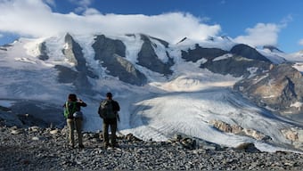 Hikers take a picture of Pers Glacier amid climate change, in Pontresina, Switzerland. Representational Image/Reuters