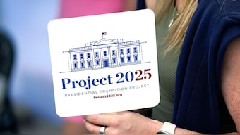 A woman holds a Project 2025 fan in the group's tent at the Iowa State Fair in Des Moines, Iowa. File image/AP