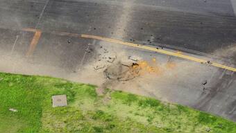 Part of a damaged taxiway at Miyazaki airport. X