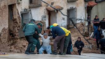 Members of emergency services rescue people trapped in their homes after floods in Letur, Albacete. AP